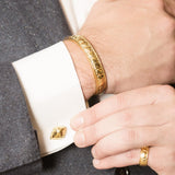 Model Wearing Pangolin Shield Cufflinks in 18K Gold, Pangolin Shield Bangle in 18K Gold and Pangolin Shield Ring in 18K Gold